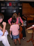 A young attendee shows interest in the viol.