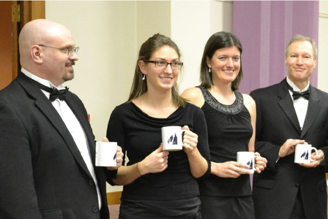 Guest artists with their anniversary mugs at the reception